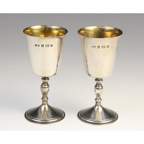 73 - A pair of silver goblets by Deakin & Francis, Birmingham 1972, each of tapered form with gilt interi... 