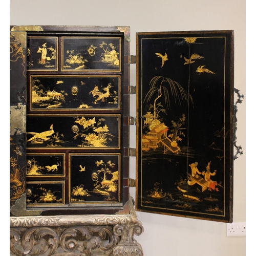 742 - A Chinoiserie lacquered cabinet on stand, 17th/18th century, the painted European wood and gesso Roc... 