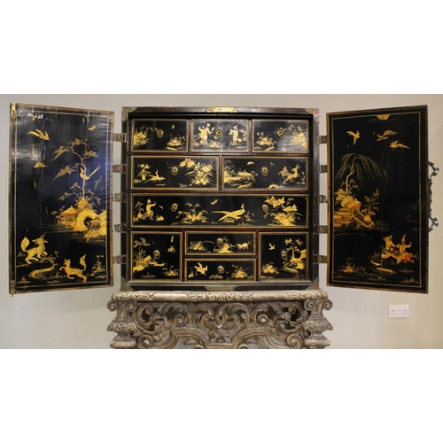 742 - A Chinoiserie lacquered cabinet on stand, 17th/18th century, the painted European wood and gesso Roc... 