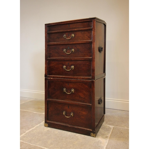 743 - A George III teak campaign style clerk’s desk, the hinged canted slope above three graduated drawers... 