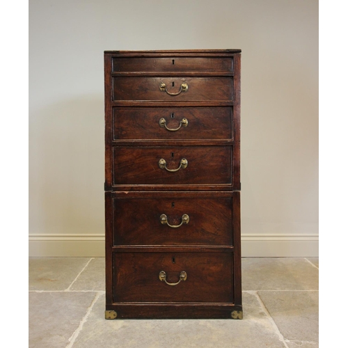 743 - A George III teak campaign style clerk’s desk, the hinged canted slope above three graduated drawers... 