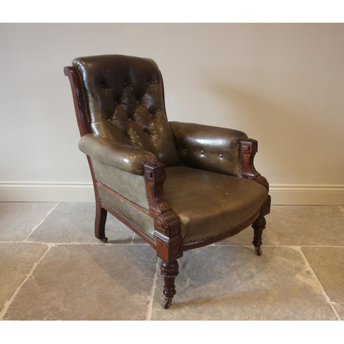 754 - A late Victorian green leather and walnut drawing room chair, the button back over padded arms exten... 