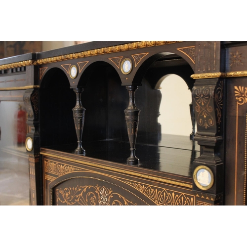 755 - A late Victorian ebonised Aesthetic movement inverted breakfront credenza, having a central arcaded ... 