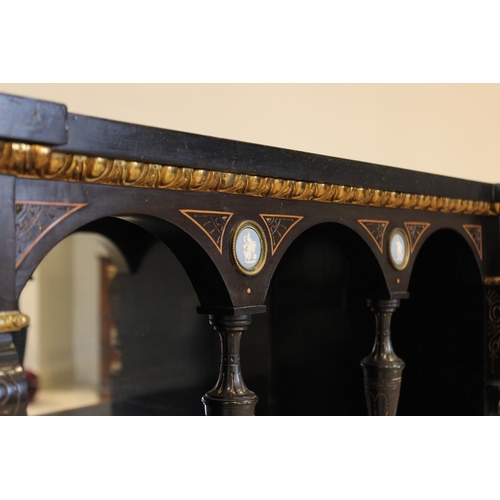 755 - A late Victorian ebonised Aesthetic movement inverted breakfront credenza, having a central arcaded ... 