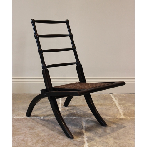 756 - A 19th century ebonised beech wood folding campaign chair, the four tapering rungs above a reinforce... 