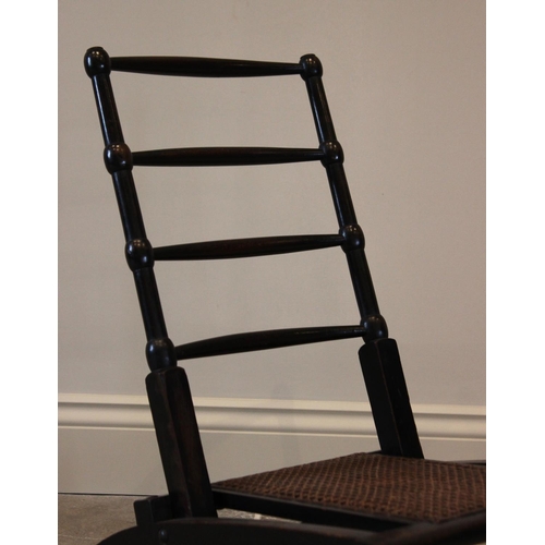 756 - A 19th century ebonised beech wood folding campaign chair, the four tapering rungs above a reinforce... 