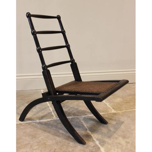 756 - A 19th century ebonised beech wood folding campaign chair, the four tapering rungs above a reinforce... 