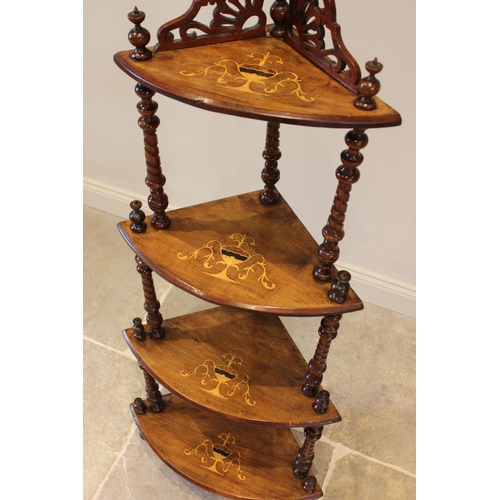 757 - A Victorian walnut freestanding corner what-not, with a fret work gallery over four graduated tiers,... 