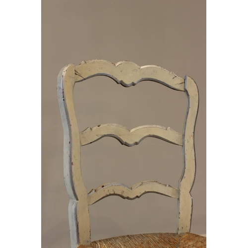 760 - A painted French style rush seated ladder back kitchen chair, 93cm high, along with a painted Regenc... 