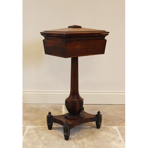 761 - A William IV rosewood teapoy, the sarcophagus shaped caddy opening to three hinged compartments and ... 