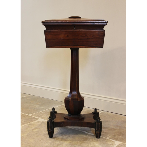 761 - A William IV rosewood teapoy, the sarcophagus shaped caddy opening to three hinged compartments and ... 