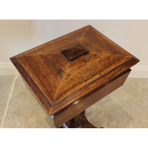 761 - A William IV rosewood teapoy, the sarcophagus shaped caddy opening to three hinged compartments and ... 