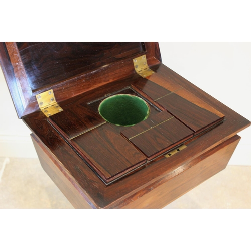 761 - A William IV rosewood teapoy, the sarcophagus shaped caddy opening to three hinged compartments and ... 