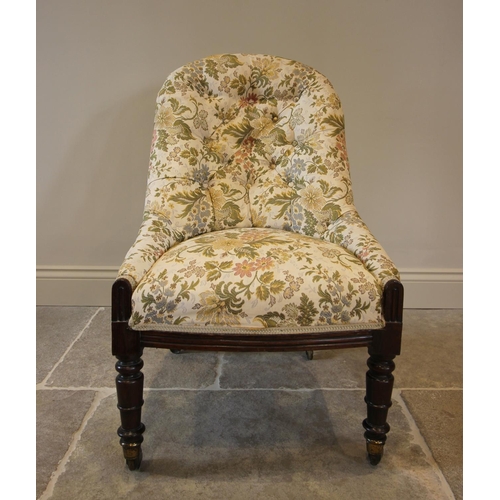 762 - A Victorian button back nursing chair, in floral fabric, raised upon ring turned walnut front legs, ... 