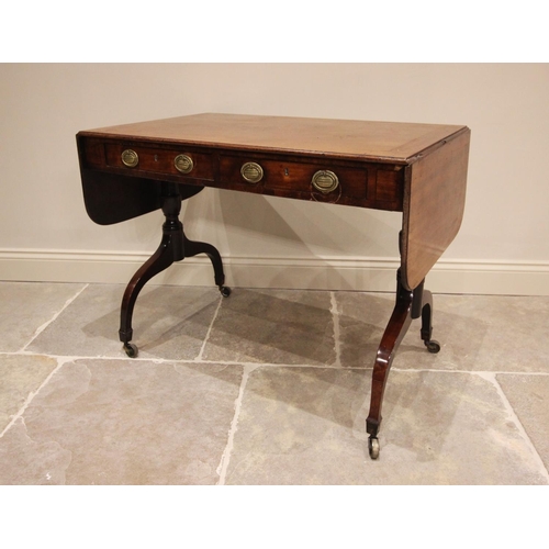 765 - An early 19th century mahogany sofa table, the rectangular top above two drawers, terminating with t... 