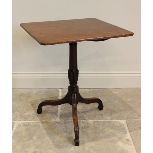 770 - An early 19th century mahogany tripod table, the square top with rounded corners upon a tapering col... 