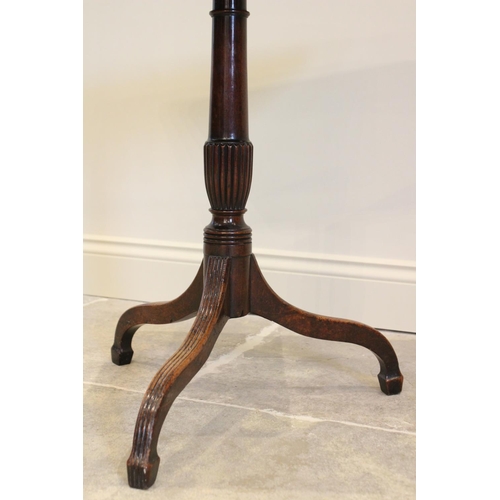 770 - An early 19th century mahogany tripod table, the square top with rounded corners upon a tapering col... 