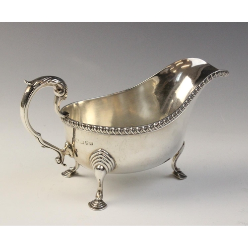 78 - A George V silver sauce boat, Chester 1932 (maker’s marks worn), of typical from with reeded border ... 