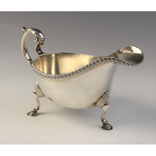 78 - A George V silver sauce boat, Chester 1932 (maker’s marks worn), of typical from with reeded border ... 