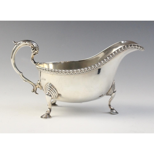 78 - A George V silver sauce boat, Chester 1932 (maker’s marks worn), of typical from with reeded border ... 