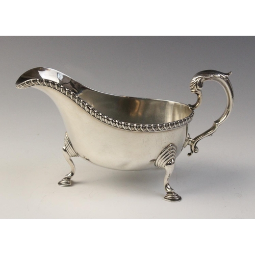 78 - A George V silver sauce boat, Chester 1932 (maker’s marks worn), of typical from with reeded border ... 