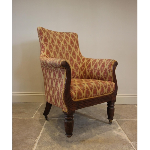 782 - A William IV mahogany and upholstered Empire style library chair, the padded arms above a reeded apr... 