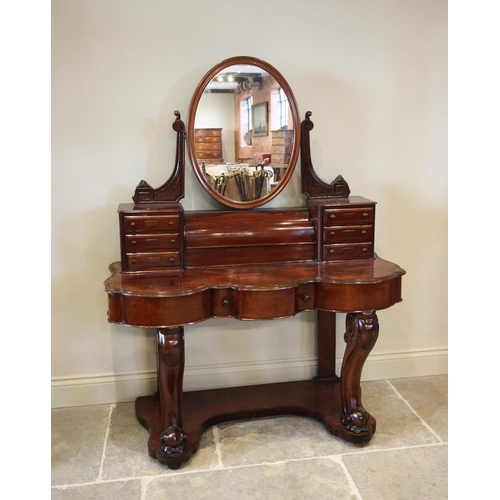 789 - A Victorian mahogany Duchess dressing table, the tilting oval mirror above a fall front cylindrical ... 