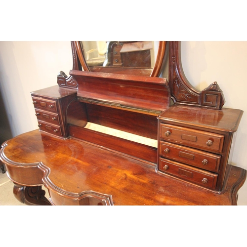 789 - A Victorian mahogany Duchess dressing table, the tilting oval mirror above a fall front cylindrical ... 