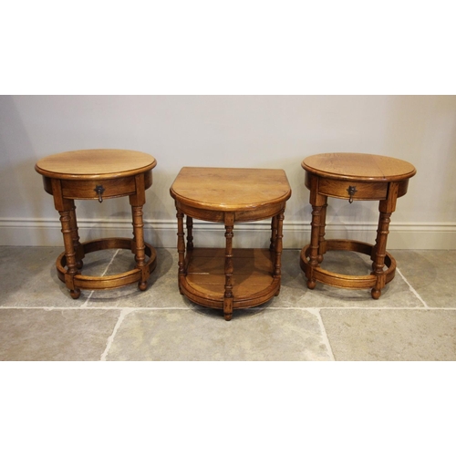 791 - A pair of reproduction golden oak lamp tables, late 20th century, each with a circular moulded top a... 