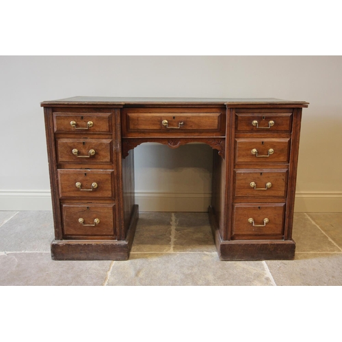 796 - An Edwardian walnut inverted breakfront pedestal desk, the gilt tooled green skiver writing surface ... 