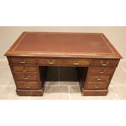 799 - An early 20th century walnut pedestal desk, the leather inset rectangular top with three drawers upo... 