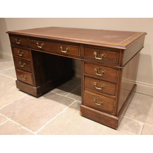 799 - An early 20th century walnut pedestal desk, the leather inset rectangular top with three drawers upo... 