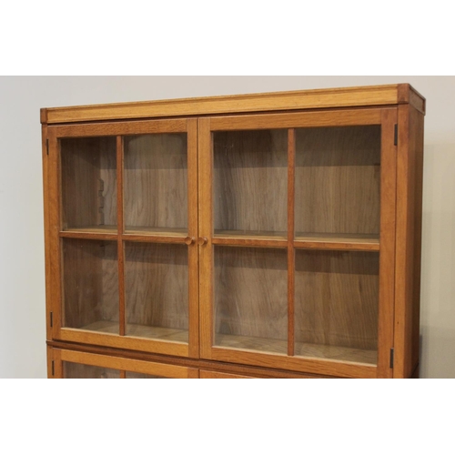 803 - A pair of early/mid 20th century oak glazed bookcases, each with a pair of four panel glazed doors, ... 