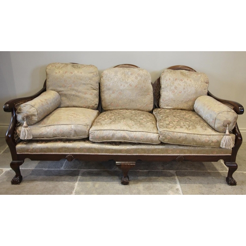 807 - An early 20th century stained beech wood three piece bergere suite, the settee with three shaped ova... 