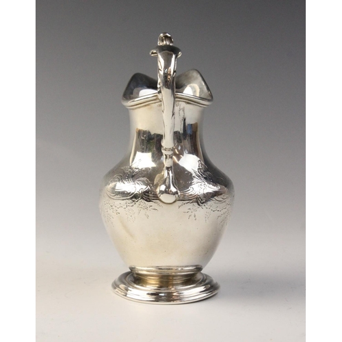 87 - A Scottish Victorian silver jug, possibly by James McKay, Edinburgh 1860, of baluster form on steppe... 