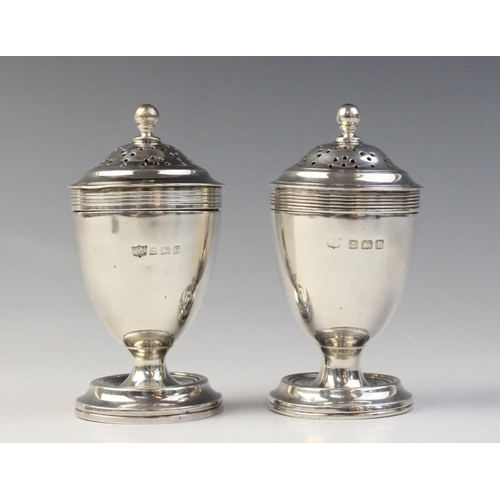 88 - A pair of George V silver pepperettes by S Blanckensee & Son Ltd, Birmingham 1914, each of urn form ... 