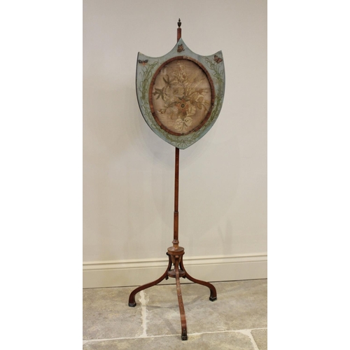 746 - An early 19th century satinwood pole screen, the shield shaped screen with a glazed oval needlework ... 