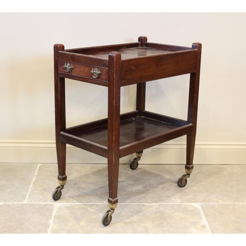 747 - An early 20th century mahogany tea trolley, the upper galleried tray with a single frieze drawer opp... 