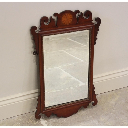 802 - An Edwardian, George III style fretwork mirror, with rectangular bevelled plate below an inlaid fan ... 