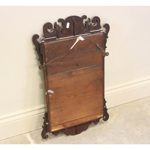 802 - An Edwardian, George III style fretwork mirror, with rectangular bevelled plate below an inlaid fan ... 