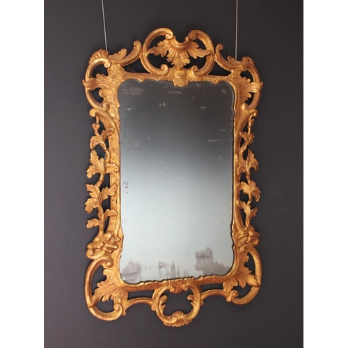 766 - A pair of 18th century Rococo style gilt wood wall mirrors circa 1760, the C scroll openwork frames ... 