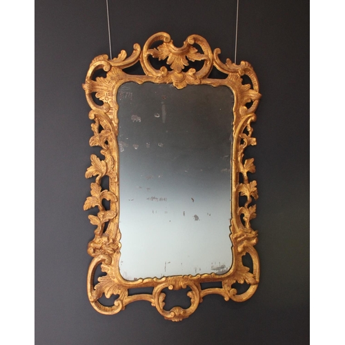 766 - A pair of 18th century Rococo style gilt wood wall mirrors circa 1760, the C scroll openwork frames ... 