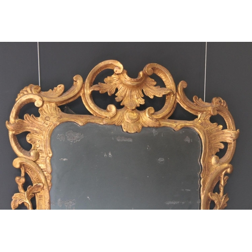 766 - A pair of 18th century Rococo style gilt wood wall mirrors circa 1760, the C scroll openwork frames ... 