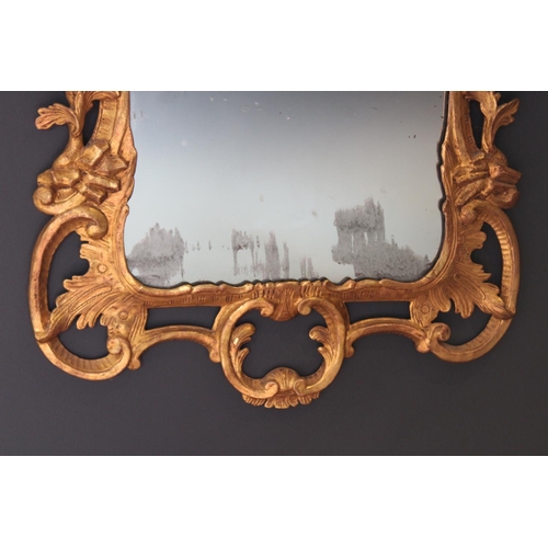 766 - A pair of 18th century Rococo style gilt wood wall mirrors circa 1760, the C scroll openwork frames ... 