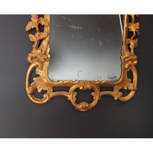 766 - A pair of 18th century Rococo style gilt wood wall mirrors circa 1760, the C scroll openwork frames ... 