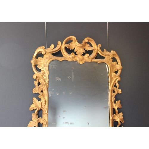 766 - A pair of 18th century Rococo style gilt wood wall mirrors circa 1760, the C scroll openwork frames ... 