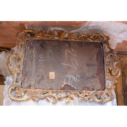 766 - A pair of 18th century Rococo style gilt wood wall mirrors circa 1760, the C scroll openwork frames ... 