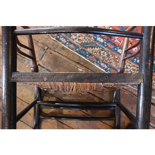 798 - William Morris, an Arts & Crafts Sussex type chair, the gentle concave back rail with four ring turn... 