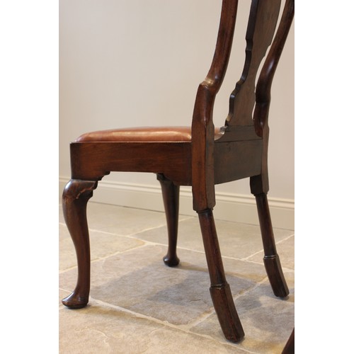 678 - A pair of George I walnut side chairs, each with a vase shaped splat over a drop in upholstered seat... 