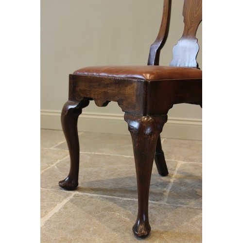 678 - A pair of George I walnut side chairs, each with a vase shaped splat over a drop in upholstered seat... 